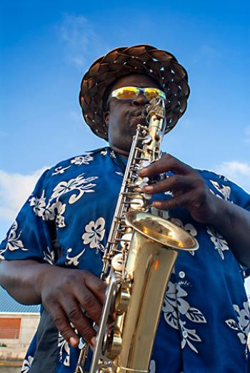 Musician playing the saxophone near the port of Nassau, New Providence Island, The Bahamas, Caribbean.